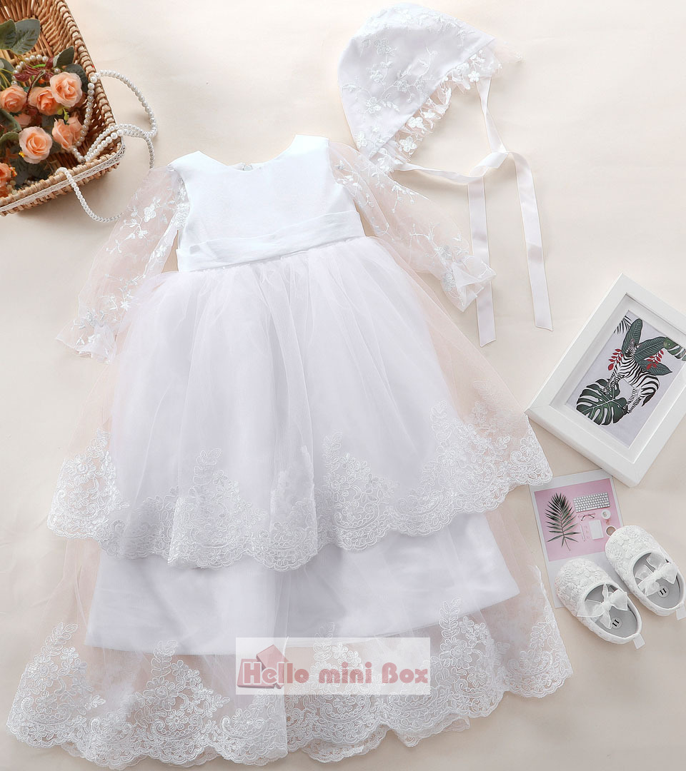 Delicate double lace christening dress with a big bow on the back